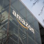 Amazon logo on glass office building, representing the company's global business presence