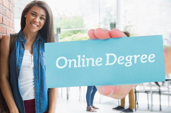 Student holding online degree card